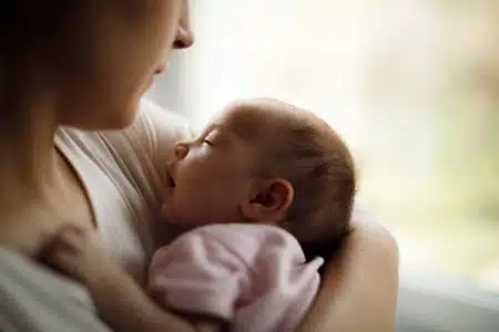 Catholic adoption agency mother holding her newly adopted baby