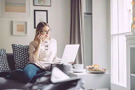 CatholicWomanContacingLifetime Catholic woman calling Lifetime looking at her laptop
