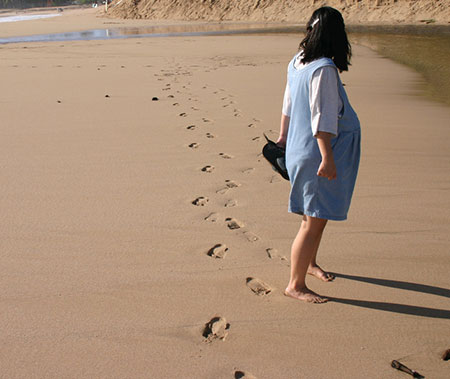 pregnant woman walking thinking about Catholic adoption for her baby