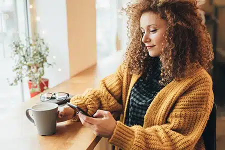 young woman looking at Catholic parents online in her adoption process