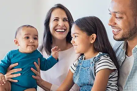 family laughs together talking about their family tree