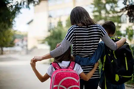 mom talks with teens about open adoption on a walk