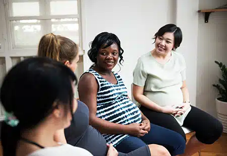 pregnant women talking together about birth mother stereotypes